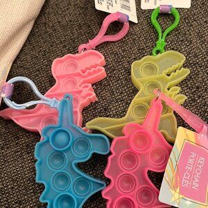 Free Pop It Keychain or Backpack Clip with $25 Purchase (Dinosaur and Unicorn)